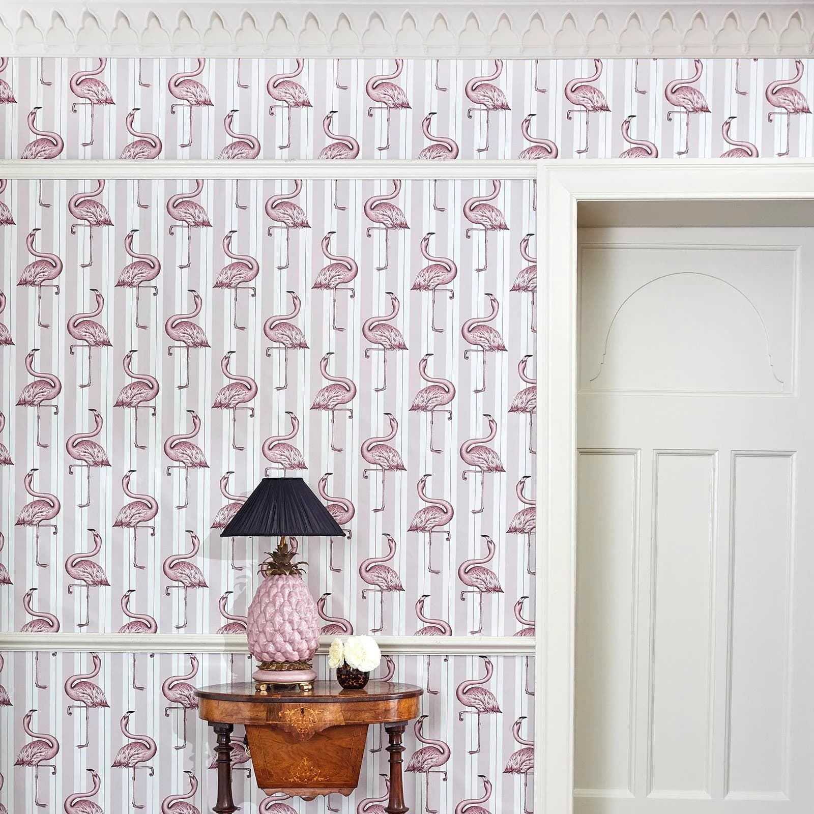 The Flamingo Wing wallpaper in macaroon pink, hung on a wall