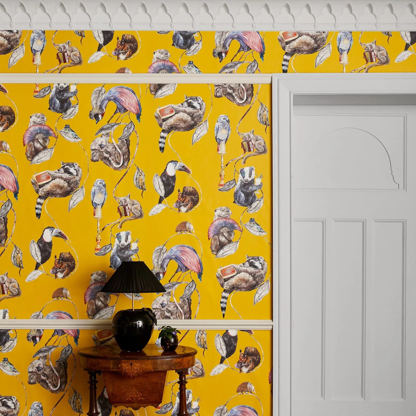 The Theatre Stripe wallpaper in ochre, hung on a wall